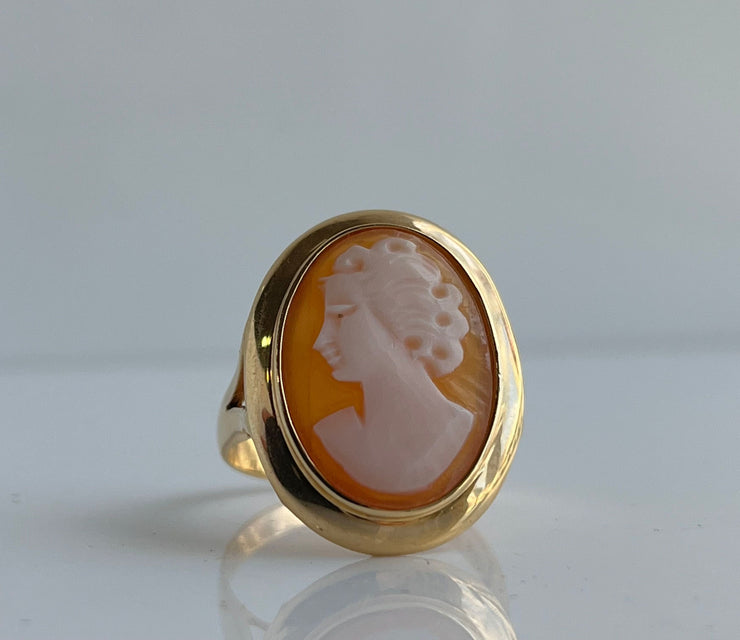 Close detail of vintage hand-carved cameo ring set in warm 14k yellow gold.