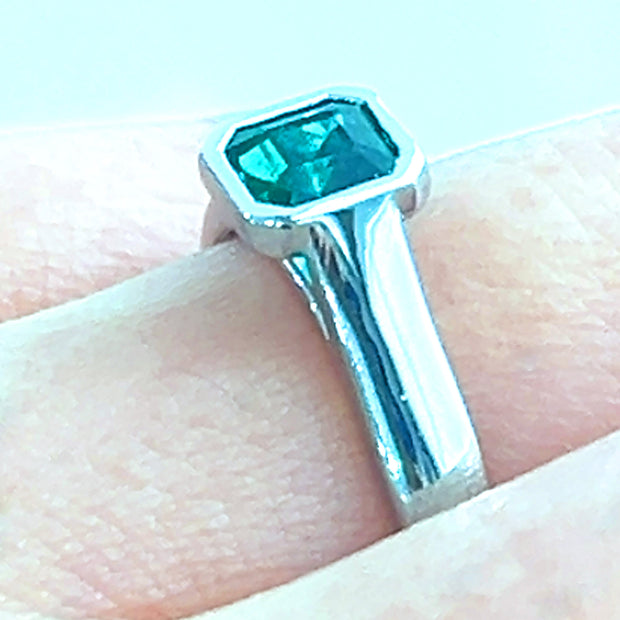 Emerald white gold bezel ring