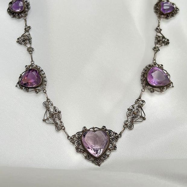 Vintage heart-shaped amethyst necklace with an 18ct rose-cut amethyst, surrounded by intricate detailed gold accents.gold.