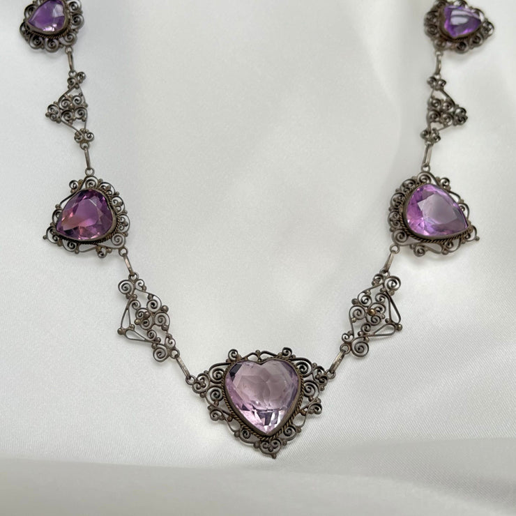 Vintage heart-shaped amethyst necklace with an 18ct rose-cut amethyst, surrounded by intricate detailed gold accents.gold.