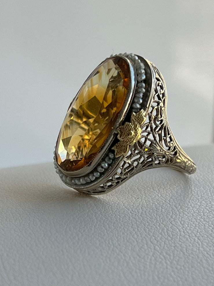 Unique Vintage Citrine & Seed Pearl Halo Ring Artfully crafted in 14K gold with intricate, classic detail.