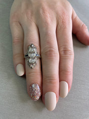 Shown on hand this ring is an elegant arrangement of diamonds and sapphires, perfect for a love that endures forever.
