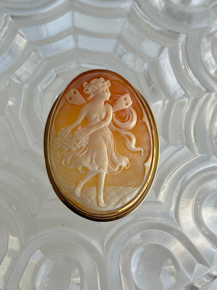 A straight-on view of the brooch showcases the finely carved antique cameo, depicting a classical female with delicate features. The soft ivory tones of the cameo contrast beautifully with the warm glow of the solid 14K yellow gold frame, capturing timeless elegance in a single image.
