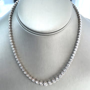 Close-up view of the necklace highlighting the 7.0 ctw total carat weight of round brilliant diamonds, showcasing their brilliance and the modern bezel setting.