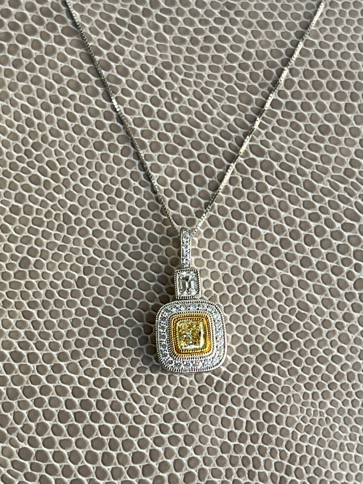 Stunning details with a diamond halo and emerald-cut accent diamond at the top.