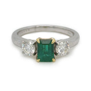 A closer look at the three stone emerald with diamond accents. 