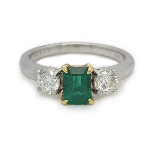 A closer look at the three stone emerald with diamond accents. 