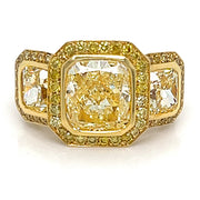 Yellow diamond three stone halo ring