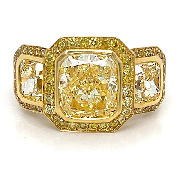 Yellow diamond three stone halo ring