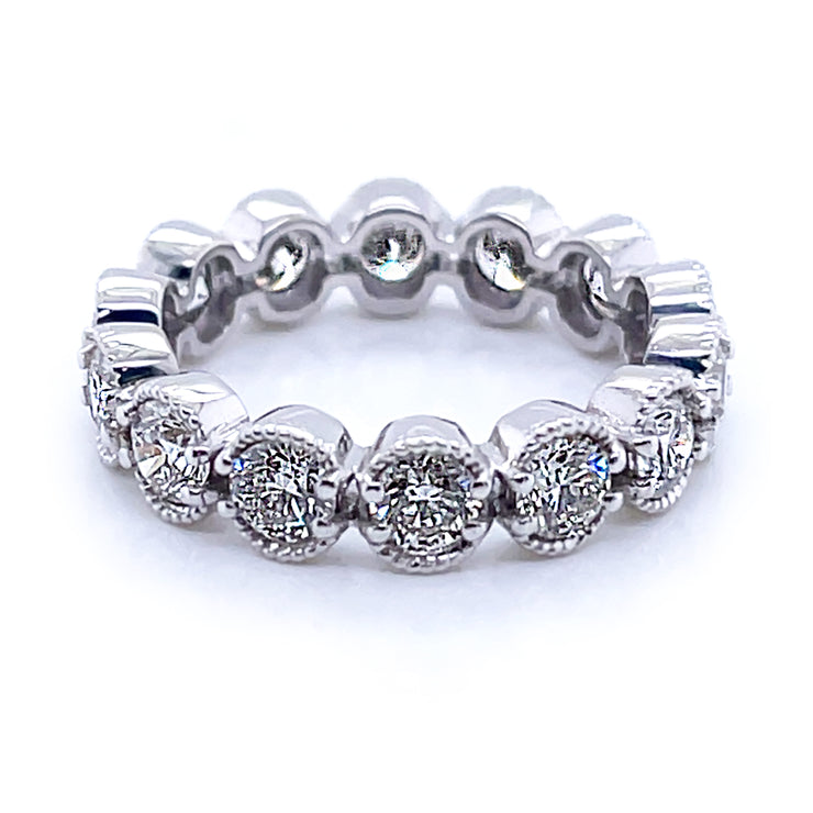 A 18K white gold wedding band ring with round brilliant cut diamonds.