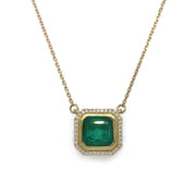 Close-up of the Asscher Cut Green Emerald Necklace, highlighting the vibrant 1.80 ct emerald surrounded by radiant diamonds in a refined 18K yellow gold setting.