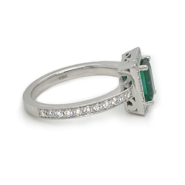 A side view of the emerald and diamond halo ring.