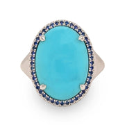 Close-up of 8.58 ct turquoise and sapphire halo ring in 18k white gold