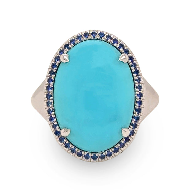 Close-up of 8.58 ct turquoise and sapphire halo ring in 18k white gold