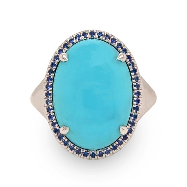 Close-up of 8.58 ct turquoise and sapphire halo ring in 18k white gold