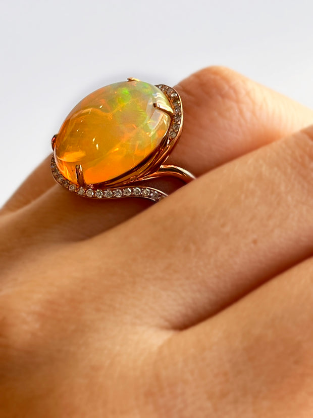 Close detail of the fire inside the opal with accent diamond halo for added sparkle.