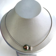 Shown from above shacasing the luster of the lack pearl next to the cool pave diamonds.