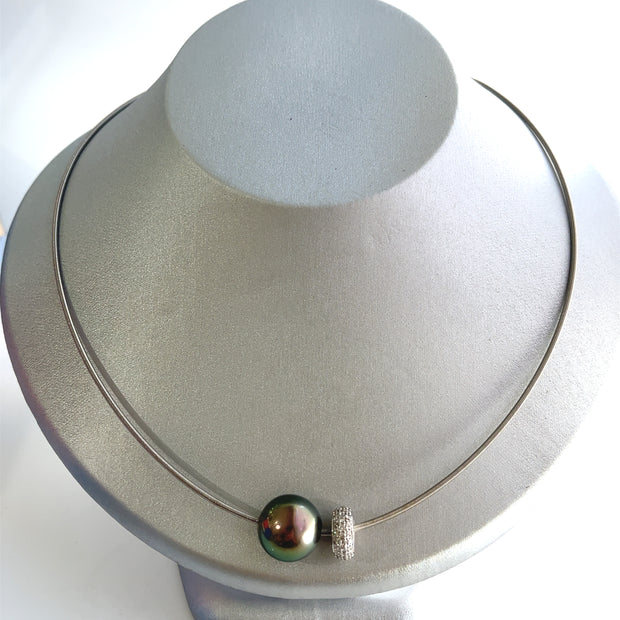 Shown from above shacasing the luster of the lack pearl next to the cool pave diamonds.