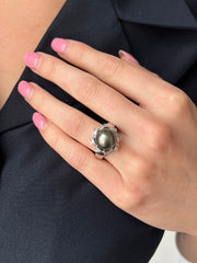 Black sea pearl and diamond ring shown on hand.