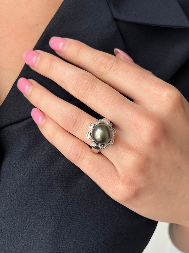 Black sea pearl and diamond ring shown on hand.