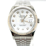 A close up detailing the white dial and diamond markers.