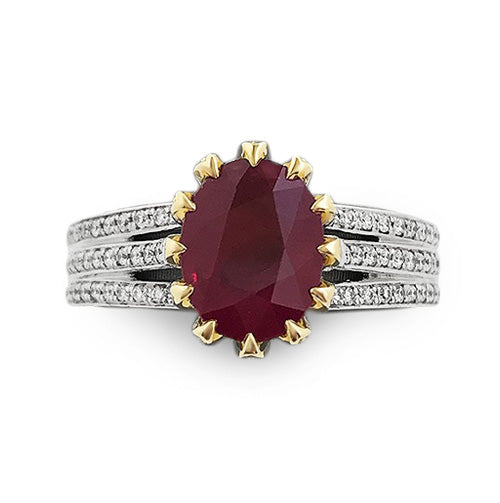 18k white and yellow gold ring featuring a 2.10 ct oval ruby in a pavé diamond basket with triple pavé diamond rows on the white gold shank.