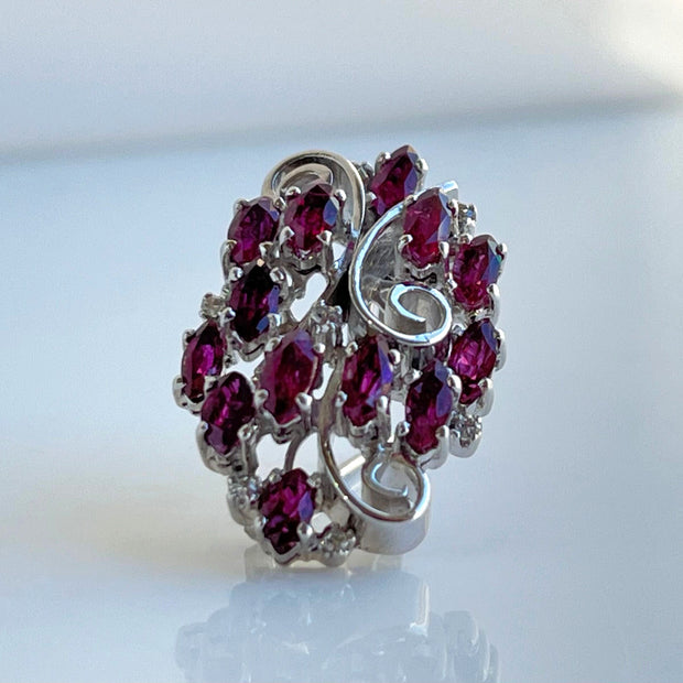 Featuring 2.0ctw marquise rubies and 0.13ctw round diamonds, this platinum pendant/brooch offers versatility
