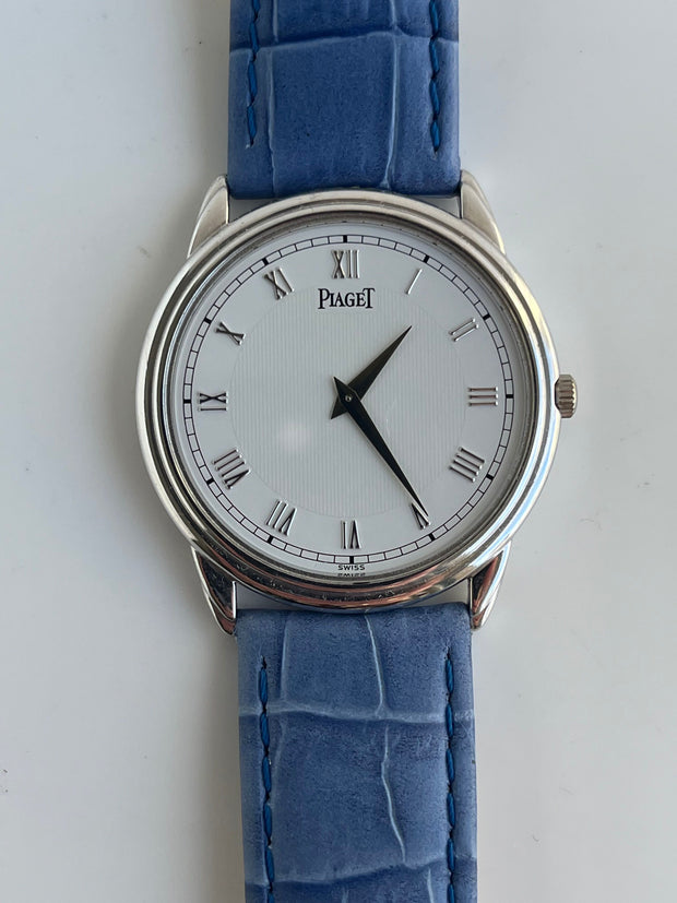 White Dial with Roman Numerals and Vertical Guilloché Center.