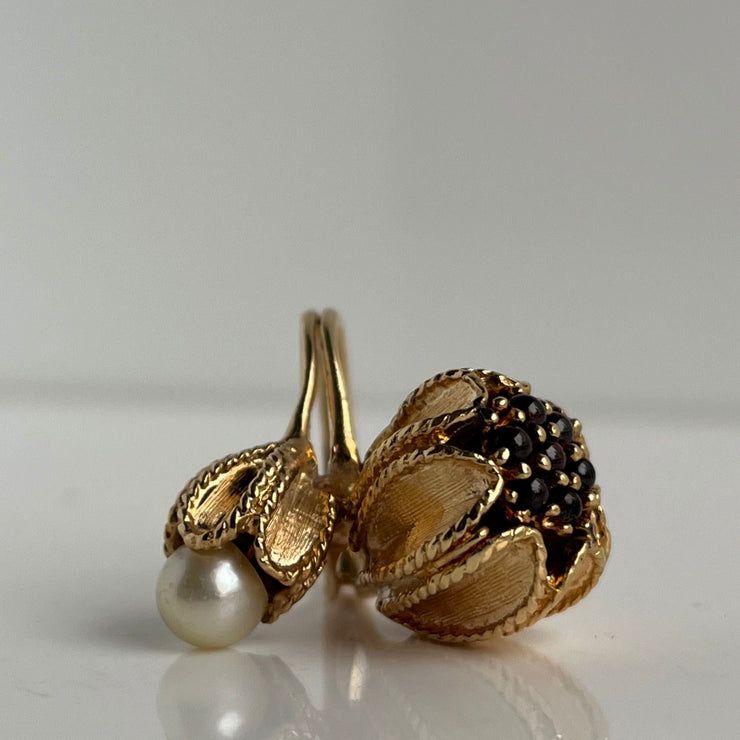 Unique antique garnet and pearl flower ring that wraps around the finger.