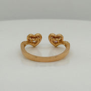 Rose gold open ring with two diamond hearts on a white background