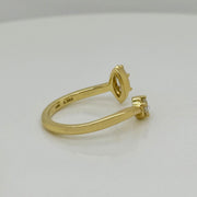 Bypass ring in 18K yellow gold featuring marquise and round brilliant cut diamonds