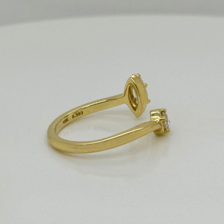 Bypass ring in 18K yellow gold featuring marquise and round brilliant cut diamonds