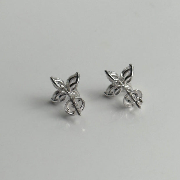 Back side of diamond stud earrings featuring marquise-cut stones on white background