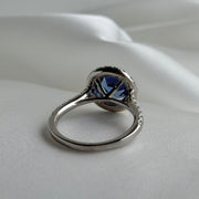 Back of luxury gemstone ring featuring deep blue sapphire and sparkling diamonds