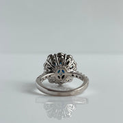 Intricate floral design on the back of sapphire and diamond ring in 14K white gold