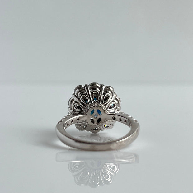 Intricate floral design on the back of sapphire and diamond ring in 14K white gold