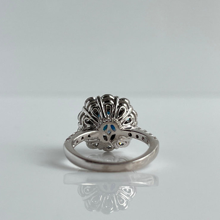 Intricate floral design on the back of sapphire and diamond ring in 14K white gold