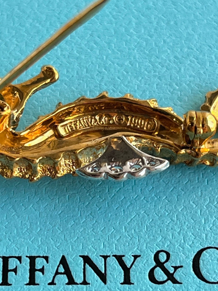 The reverse side displays the hallmark stamp reading “Tiffany & Co.” along with the year. The pin clasp is shown in excellent condition, confirming both authenticity and quality craftsmanship.