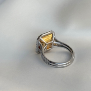 White gold ring with a yellow gold center on a light gray background