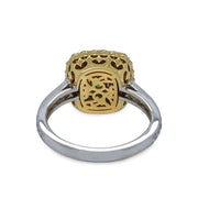 Yellow and white gold emerald ring with intricate design on a white background