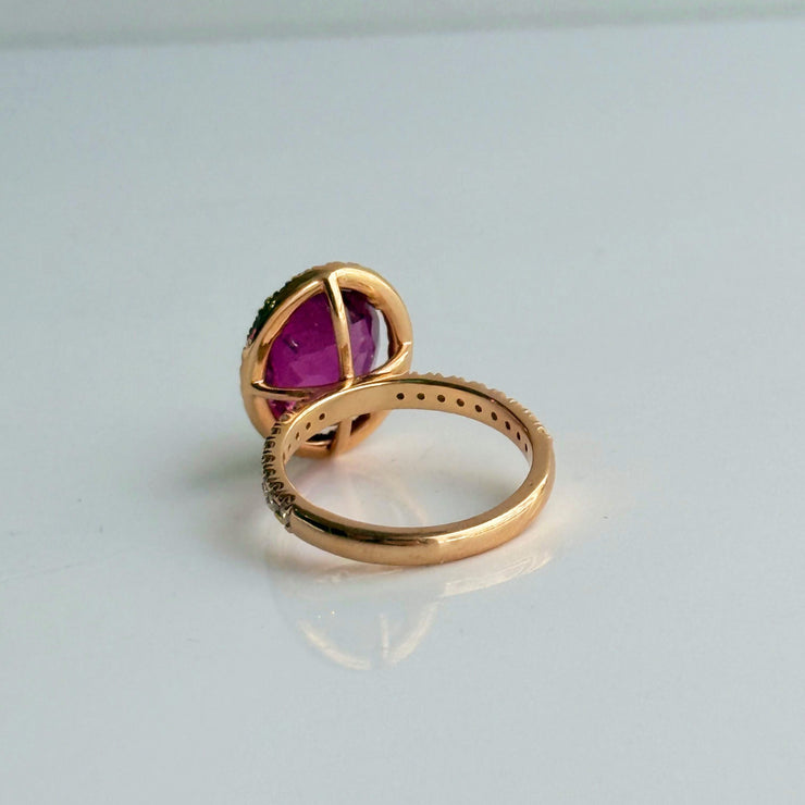 Luxury 4.67 ct oval tourmaline ring with sparkling diamond halo, set in warm 18k rose gold.