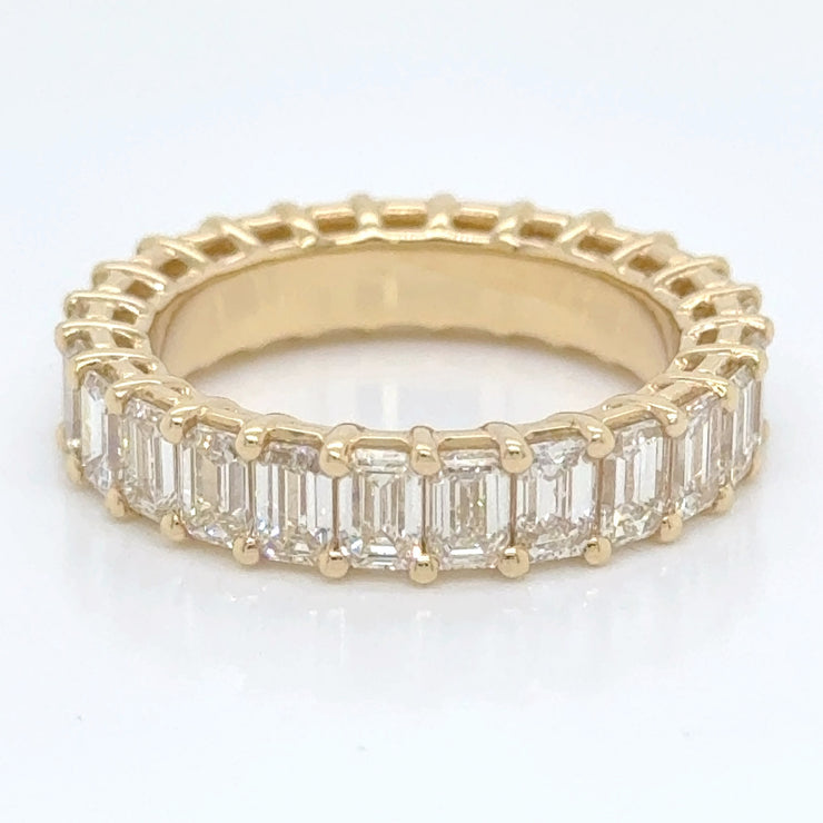 Beautifully crafted eternity ring showcasing a continuous line of emerald-cut diamonds totaling 5 carats.