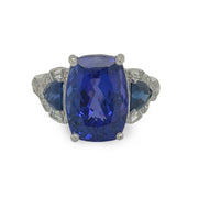 Close-up of a luxurious tanzanite ring with 8.4ct center stone and .85ctw diamond accents, crafted by R. Yard