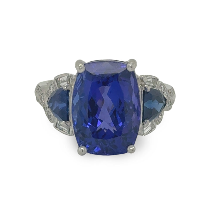 Close-up of a luxurious tanzanite ring with 8.4ct center stone and .85ctw diamond accents, crafted by R. Yard
