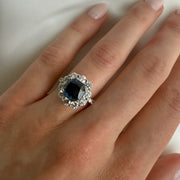 Elegant 3.7 carat sapphire engagement ring with diamond detailing, shown on a model's hand