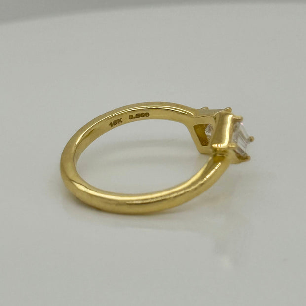 Modern gold ring featuring 0.30ct emerald cut and 0.20ct baguette diamonds