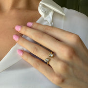 Two diamond and yellow gold diamond ring on a model's hand