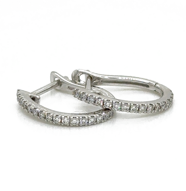 Chic 0.15 CTW Round Brilliant Diamond Mini Hoops in luxurious 18K white gold, designed for comfort and versatility.