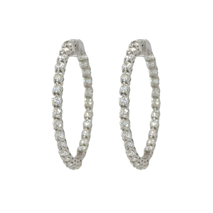 Chic diamond hoop earrings with a total carat weight of 4.5 CTW, featuring a captivating design of diamonds both inside and out in 18K white gold.