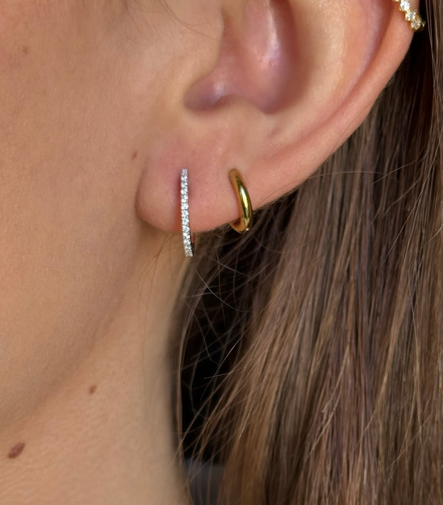 Model wearing stylish mini hoop earrings with a total carat weight of 0.15 CTW, set in 18K white gold for a timeless addition to any jewelry collection.